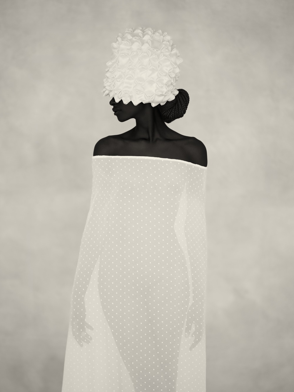 A person wrapped in a sheer dotted white fabric, wearing a textured white headpiece, standing in front of a light, soft-focus background.
